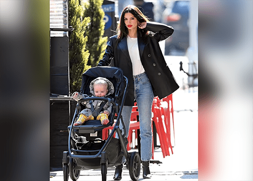 Lady Posing for a picture while walking with baby stroller as part of influencer marketing campaign